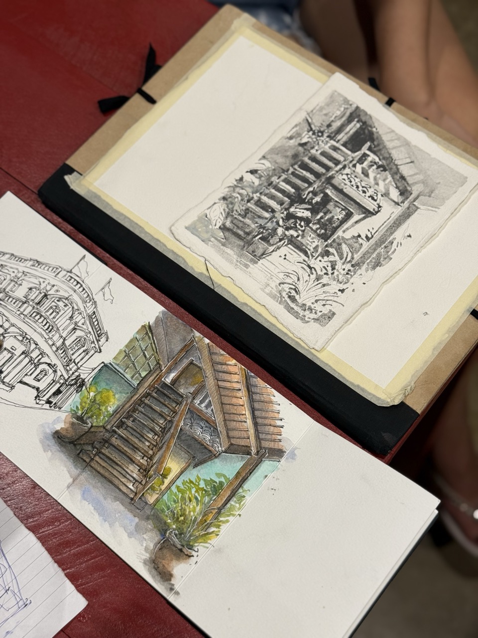 Sketch artworks laid on the red table